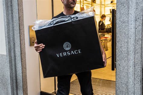 michael kors buys out versace